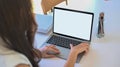 Businesswoman working on laptop computer while sitting in meeting room. Royalty Free Stock Photo