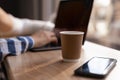 Businesswoman working on laptop computer and using mobile phone surfing the internet in coffee shop, close up, Woman Royalty Free Stock Photo