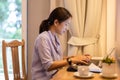 Businesswoman working on laptop in hotel room on vacation. Royalty Free Stock Photo