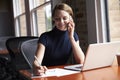 Businesswoman Working On Laptop And Making Phone Call Royalty Free Stock Photo