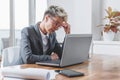 Businesswoman working on a laptop, overworking, under pressure