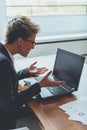 Businesswoman working on a laptop, overworking, under pressure