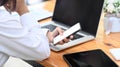 Businesswoman working with laptop and using mobile phone at office. Royalty Free Stock Photo