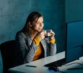businesswoman working late night business computer woman office coffee espresso drink cup energy light dark young Royalty Free Stock Photo