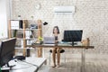 Businesswoman Working In Office With Air Conditioning