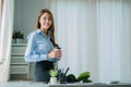 Businesswoman working in the office during coffee break smiling at the window giving a clear vision of work and success instilling