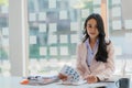 Businesswoman working in the office during coffee break smiling at the window giving a clear vision of work and success instilling