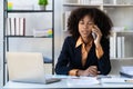 Businesswoman working in office connecting, contacting and chatting with customers. Professional woman plans table with smartphone