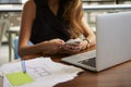 Businesswoman working in office using phone, mid section Royalty Free Stock Photo