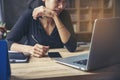 Businesswoman working online at the home office via laptop. Asian young entrepreneurs watching webinars and talking during meeting Royalty Free Stock Photo