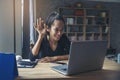 Businesswoman working online at the home office via laptop. Asian young entrepreneurs watching webinars and talking during meeting Royalty Free Stock Photo