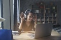 Businesswoman working online at the home office via laptop. Asian young entrepreneurs watching webinars and talking during meeting Royalty Free Stock Photo