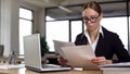 Businesswoman working with papers, checking annual financial report in office Royalty Free Stock Photo