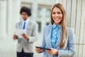 Businesswoman working on tablet computer outside office Royalty Free Stock Photo