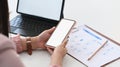 Businesswoman working with tablet computer and using mobile phone on office desk. Royalty Free Stock Photo