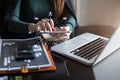 Businesswoman working with tablet and using a calculator to calculate the numbers of static in office. Finance accounting concept Royalty Free Stock Photo