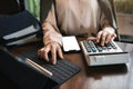 Businesswoman working with tablet and using a calculator to calculate the numbers of static in office. Finance accounting concept Royalty Free Stock Photo