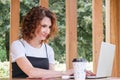 Businesswoman works at a laptop in a coworking space in a city park