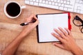 Businesswoman writing on diary on desk Royalty Free Stock Photo