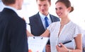 Businesswoman writing on flipchart while giving presentation to colleagues in office Royalty Free Stock Photo