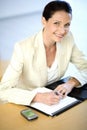 Businesswoman writing in her agenda Royalty Free Stock Photo