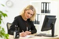 businesswoman writing on her workplace in office Royalty Free Stock Photo