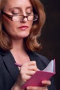 Businesswoman writing in notebook Royalty Free Stock Photo