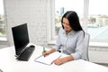 Businesswoman writing to notebook at office Royalty Free Stock Photo