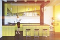 Businesswomanin a yellow pub interior Royalty Free Stock Photo