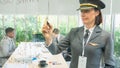 Businesswomen in airline wear pilot hat and write on board, and African man and caucasian women work together in meeting room. Royalty Free Stock Photo