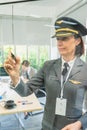 Businesswomen in airline wear pilot hat and write on board, working with staff in meeting room. Business group meeting or job Royalty Free Stock Photo