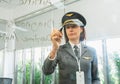 Businesswomen in airline wear pilot hat and writing on board in meeting room Royalty Free Stock Photo