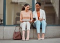 Businesswomen on a break using phone outdoors with workers browsing social media, looking at text or chat. Young, female Royalty Free Stock Photo