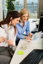 Businesswomen Discussing Graph In Office