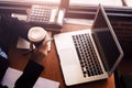 Businesswomen drink hot coffee between working. laptop, calculator and paper on the table Royalty Free Stock Photo