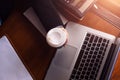 Businesswomen drink hot coffee between working. laptop, calculator and paper on the table Royalty Free Stock Photo