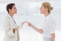 Businesswomen fighting in office Royalty Free Stock Photo