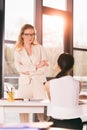 Businesswomen in formalwear talking at interview in modern office