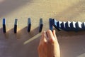 Businesswomen hand Stopping Falling wooden Dominoes effect from continuous toppled or risk Royalty Free Stock Photo