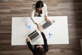 Businesswomen handshaking above office desk making successful de Royalty Free Stock Photo