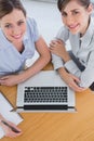 Businesswomen having a meeting and smiling up at camera Royalty Free Stock Photo