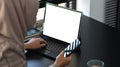 A businesswomen in hijab using laptop search and doing work in office.