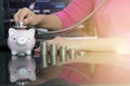 Businesswomen holding stethoscope on piggy bank and stack of coin. Concept for finance health check or cost of business, audit or