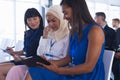 Businesswomen interacting with each other while attending business seminar Royalty Free Stock Photo