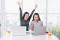 Businesswomen with laptop computer and papers showing thumbs up Royalty Free Stock Photo