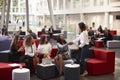 Businesswomen Meeting In Busy Lobby Of Modern Office Royalty Free Stock Photo