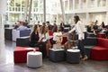 Businesswomen Meeting In Busy Lobby Of Modern Office Royalty Free Stock Photo