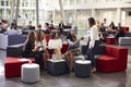 Businesswomen Meeting In Busy Lobby Of Modern Office Royalty Free Stock Photo