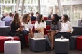 Businesswomen Meeting In Busy Lobby Of Modern Office Royalty Free Stock Photo