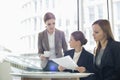 Businesswomen with paperwork during coffee break Royalty Free Stock Photo